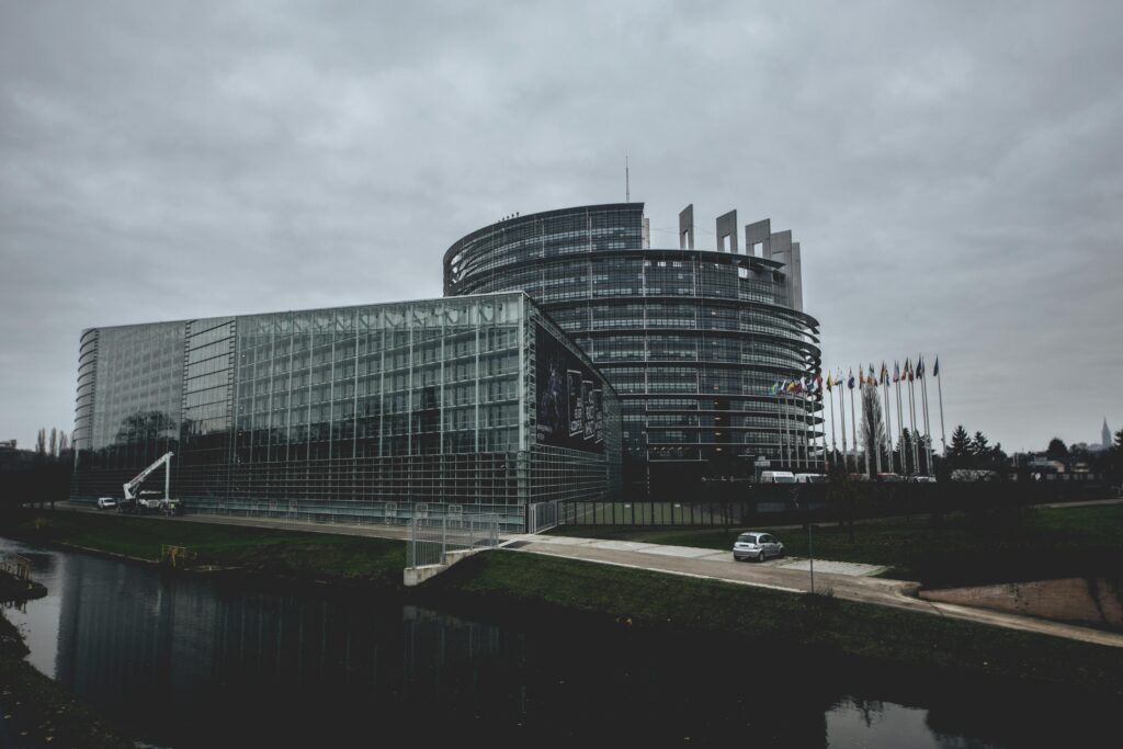 Modern architecture of the European Parliament in Strasbourg on a cloudy day.